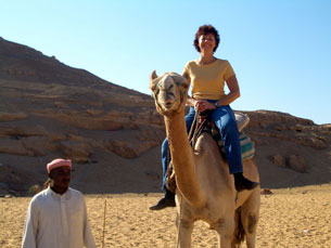 Mom Klocke and her camel smiling for the camera