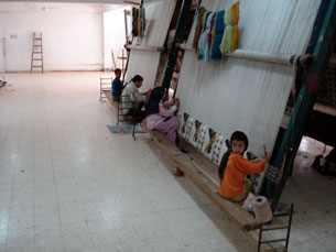 Children weaving a wool carpet at one of many carpet schools in Cairo