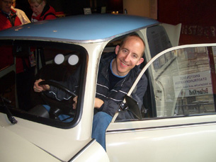 Jay sitting in a Trabant at the DDR Museum