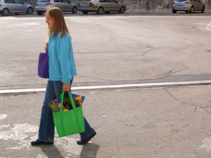 Kelly carrying a bag full of groceries