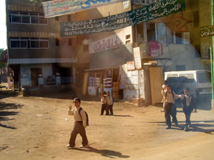 Children waving to our tour bus on our way to Sakkara